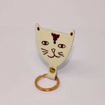 cream cat shaped leather keychain 