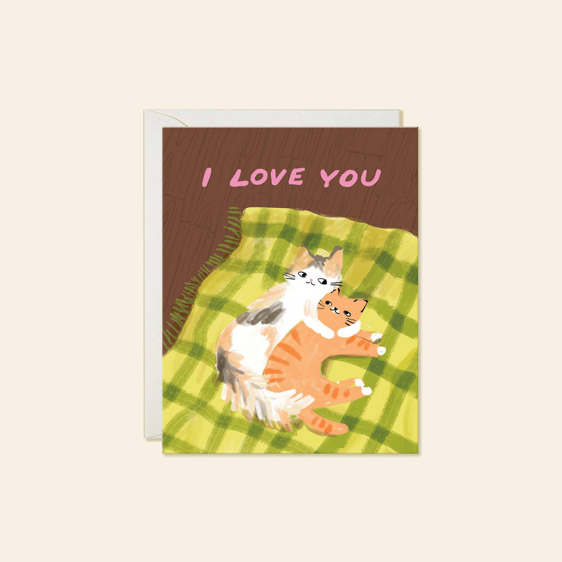 A greeting card with an illustration of two cats lying on a green plaid blanket, with a brown background and pink text reading 'I LOVE YOU'.