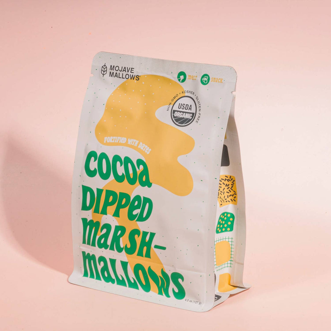 Packaging of Mojave Mallows cocoa-dipped marshmallow on a pink background