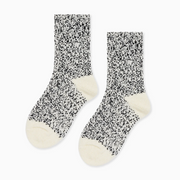 Pair of black and cream speckled socks with cream heels and toes