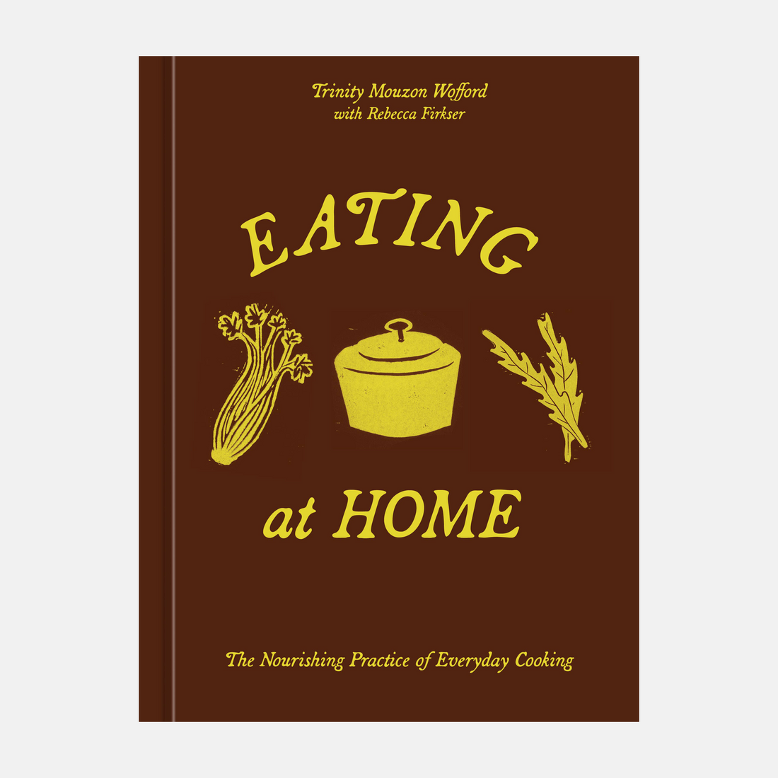 A book cover for 'Eating at Home' by Trinity Mouzon-Wefford with Rebecca Firth, featuring a dark brown background with yellow text and illustrations of vegetables, a pot, and herbs.