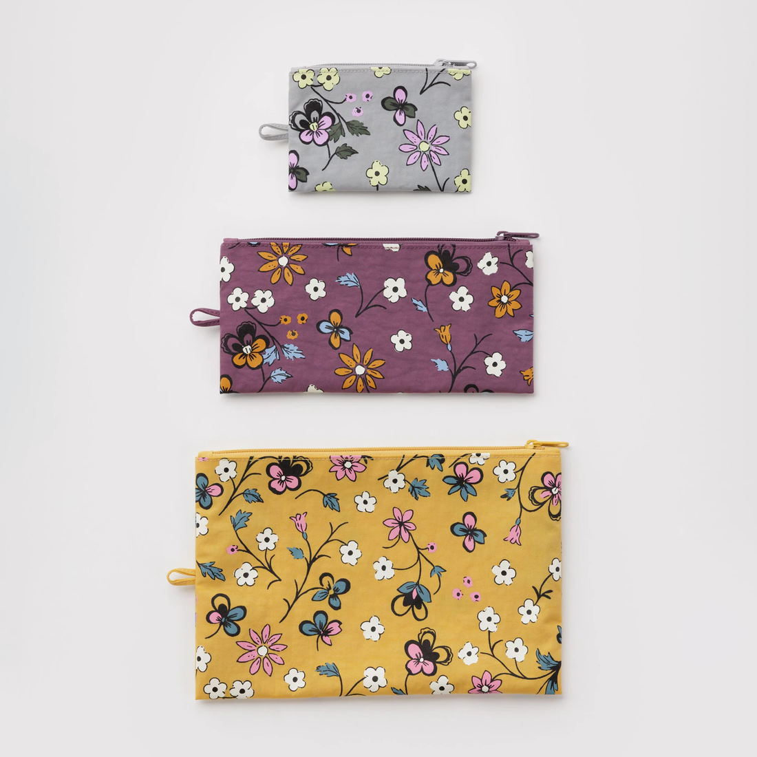 Three zippered pouches with floral  prints 