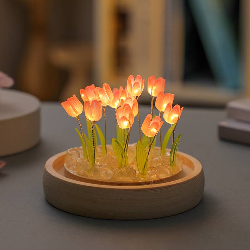 Decorative lamp with glowing tulip-shaped lights on a wooden base.