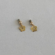 Gold flower-shaped earrings on a light gray background