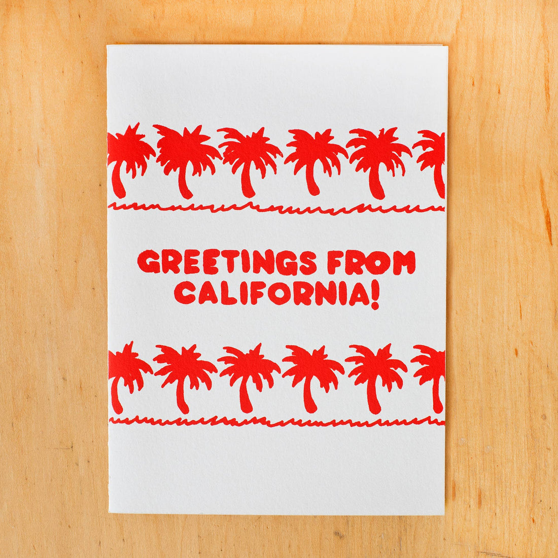 Card with red palm tree design and 'Greetings from California!' text 