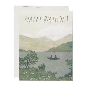 Birthday card with a scenic illustration of a lake and mountains, featuring two people in a boat.