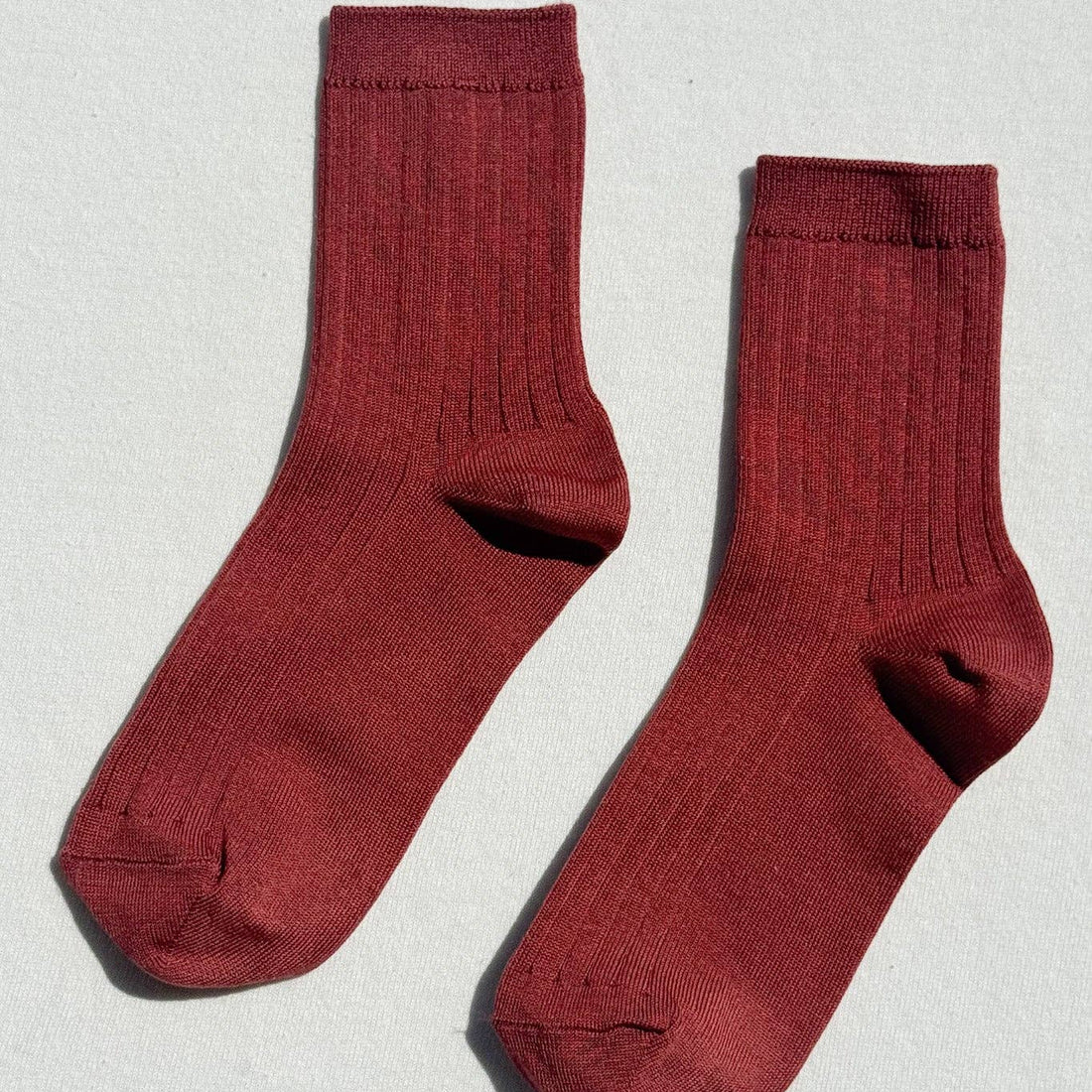 A pair of ribbed crew socks in terracotta