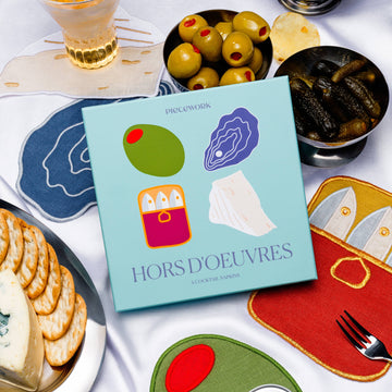 Hors d'oeuvres cocktail napkins with crackers, olives, oysters, sardines, and pickles