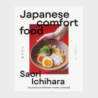 Book cover for 'Japanese comfort food' by Saori Ichihara, featuring a white background with a central photograph of a hand holding a bowl of ramen 