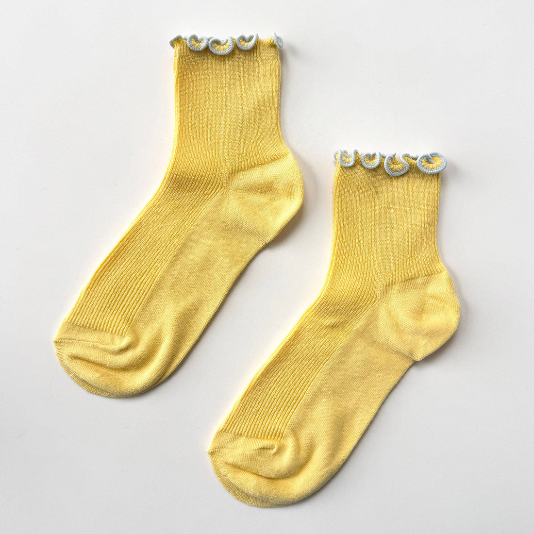 pair of yellow socks with ruflled edges