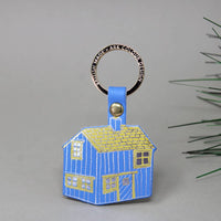 blue log cabin shaped leather keychain