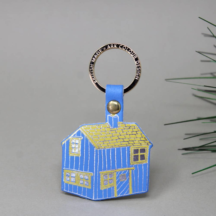 blue log cabin shaped leather keychain