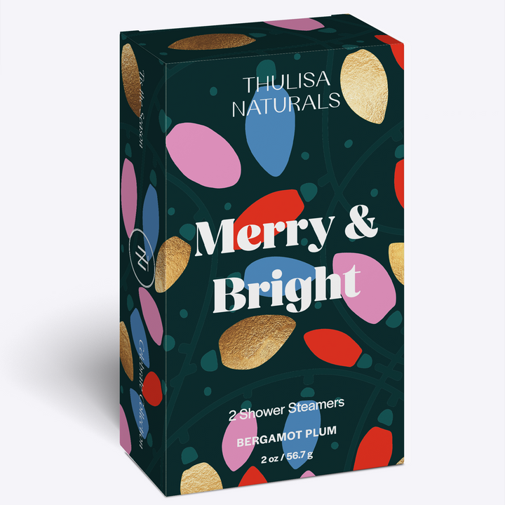 2 pack of bergamot plum scented shower steamers in a box that say merry and bright