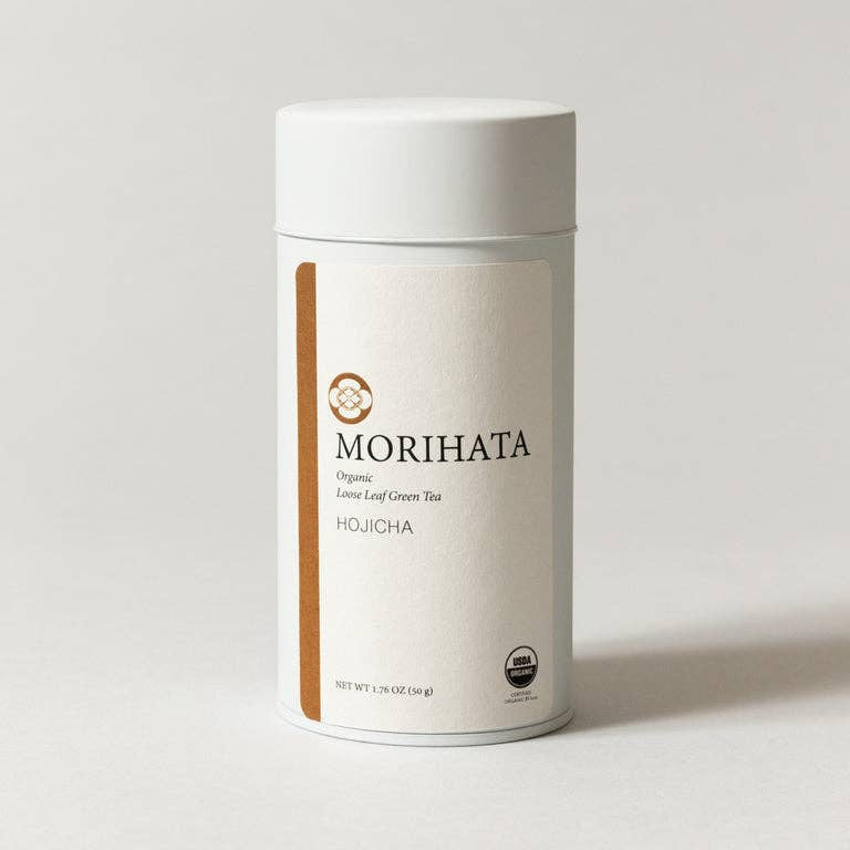 A white cylindrical canister of MORIHATA Organic Fermented Leaf Green Tea (Houicha) on a light gray background.