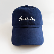 navy baseball hat with foothills lettering in white embroidery 