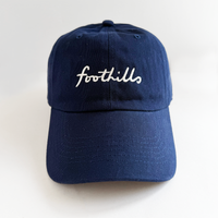 navy baseball hat with foothills lettering in white embroidery 