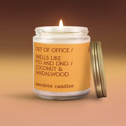 Candle in a glass jar with a gold lid, featuring a humorous label on an orange background.
