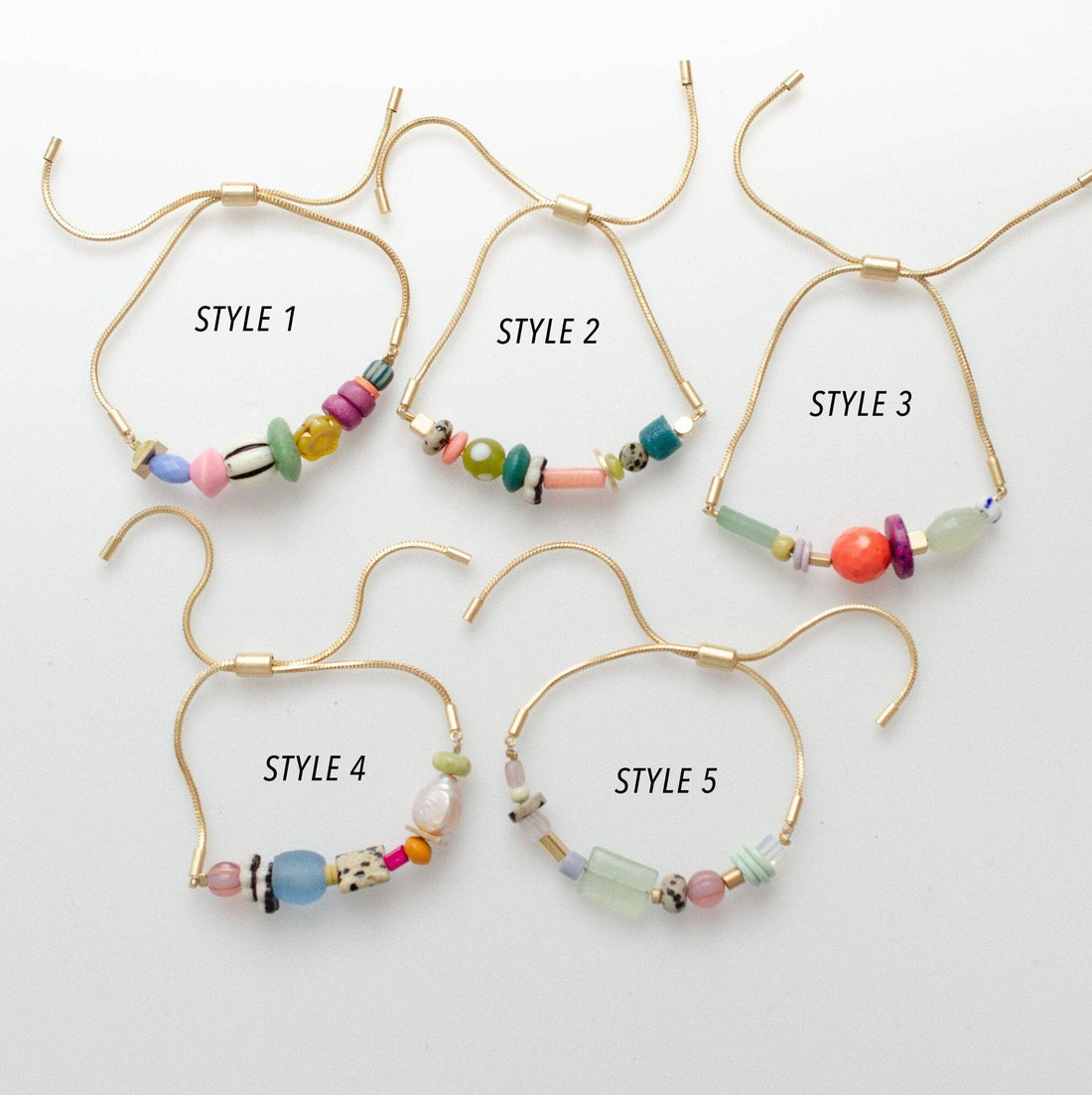 Five pairs of beaded hoop earrings on a white background, each labeled with a style number.