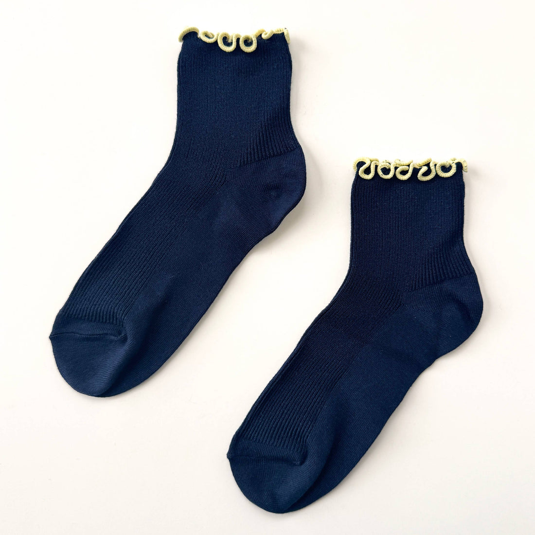 pair of navy socks with yellow trim