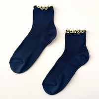 pair of navy socks with yellow trim