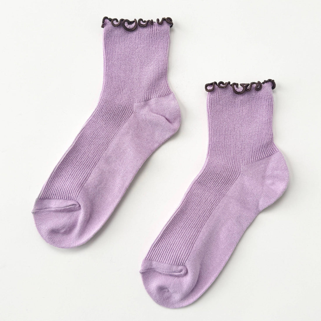 Pair of purple socks with brown trim on a white background