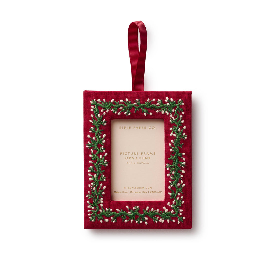 Red rectangular photo frame with greenery design on a white background