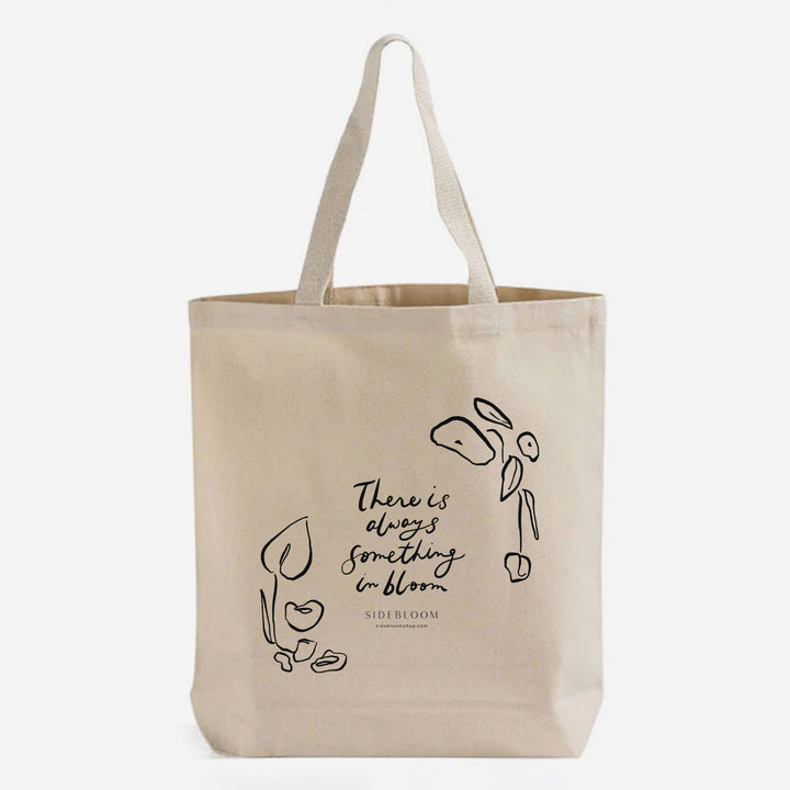 canvas tote bag with "There is always something in bloom" text by Sidebloom