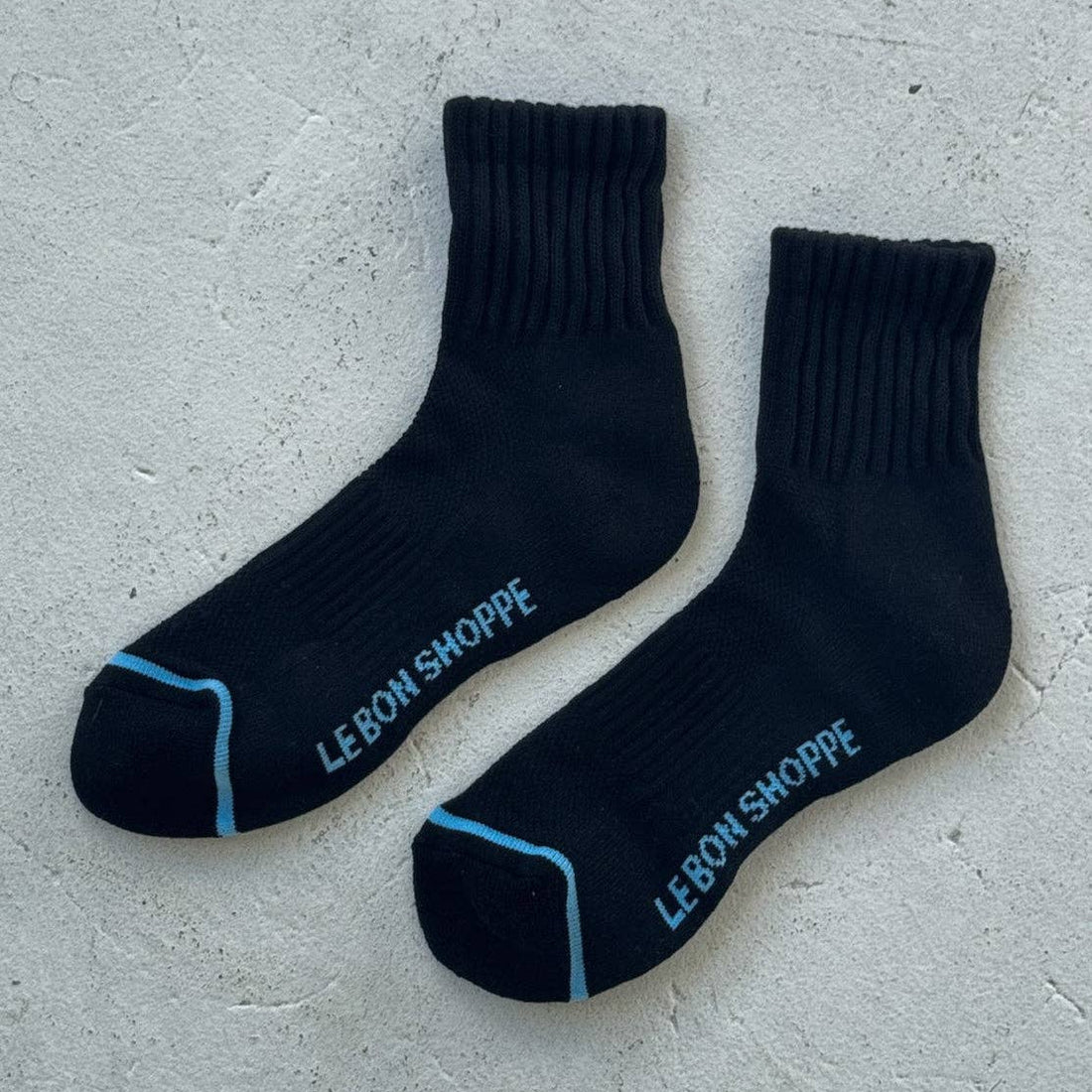 black womens socks with light blue stripe across the toe box