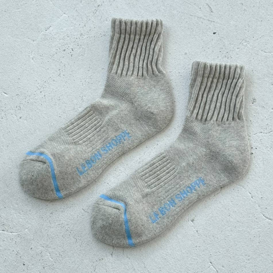 Pair of gray socks with blue accents by le bon shoppe