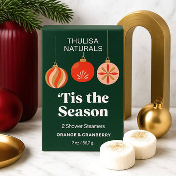 2 pack of orange and cranberry scented shower steamers in a box that says 'tis the season