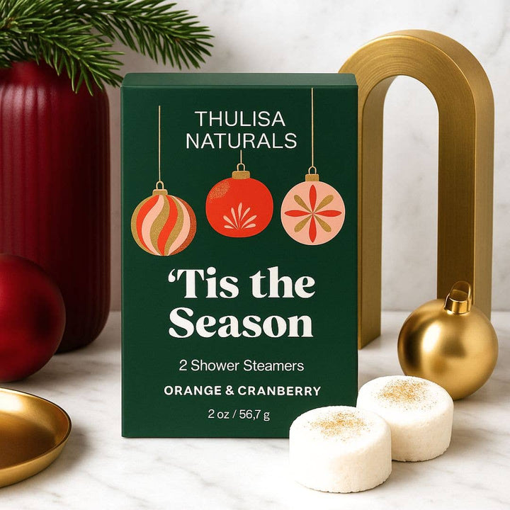 2 pack of orange and cranberry scented shower steamers in a box that says 'tis the season