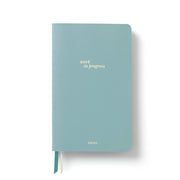 Light blue PU leather notebook with 'work in progress' text 